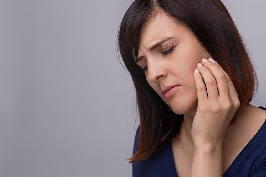 woman suffering from jaw pain