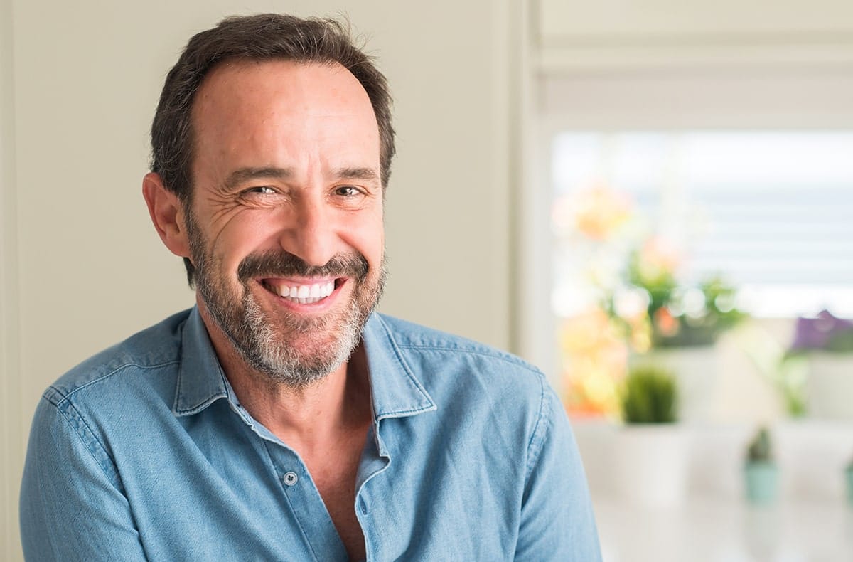 Dental bridges content image 1 Young man smiling after bad breath treatment